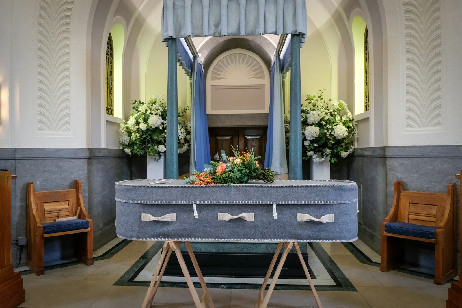 a church with a pew and flowers on it